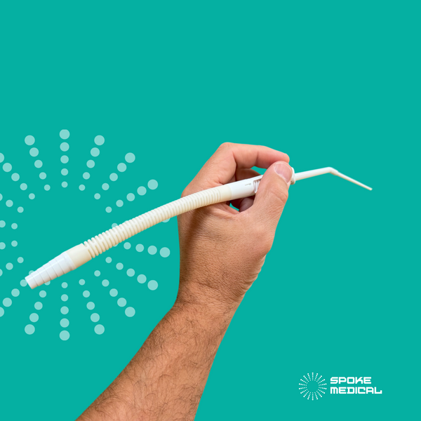 Zephyr and its adapter tube held in a pen grip, the angled tip pointing forward and the tube trailing back